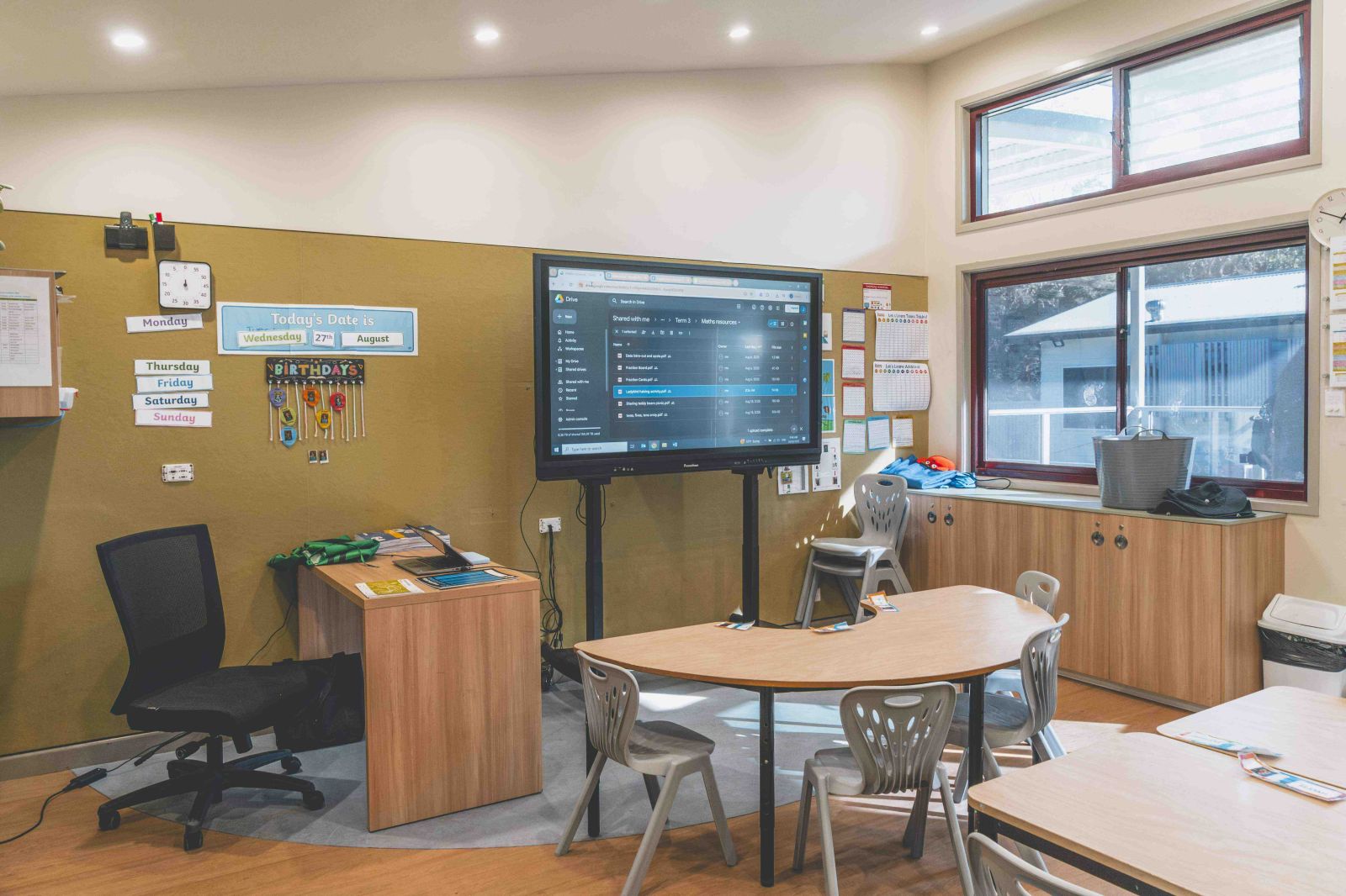 Modern classroom with interactive screen and seating areas